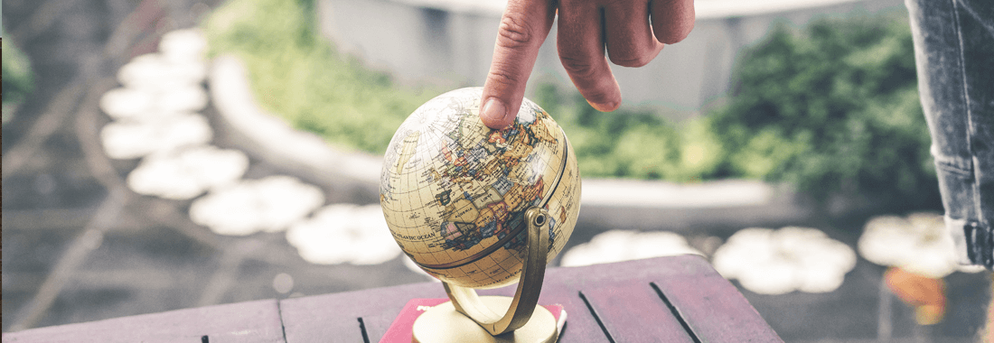 A hand is touching the globe