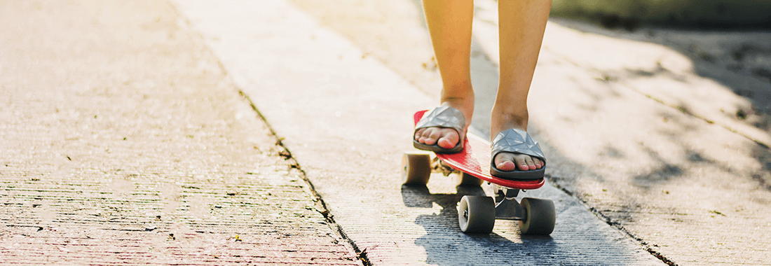 the kid is riding a skateboard