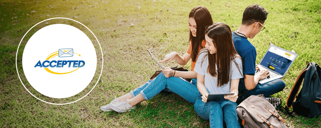 the students are sitting on the green grass