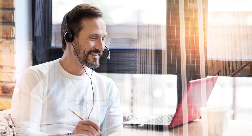 shows guy with headphones smiling