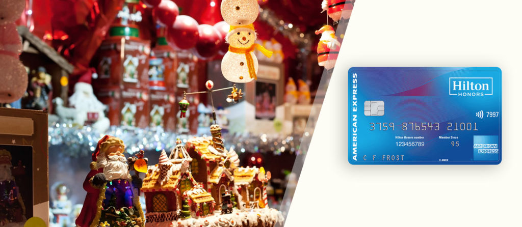 shows Hilton Honors credit card with the background of Christmas attributes and ginger house